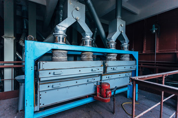 Abandoned flour milling factory. Old rusty grain cleaning air separation machines 