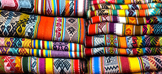 Peruvian traditional colourful native handicraft textile fabric at market in Peru, South Americain. Close up. selective focus