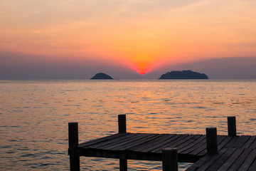 Fototapeta na wymiar Wooden pontoons on sea coast during amazing sunset.
