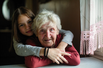 Portrait of elderly woman with her little granddaughter.