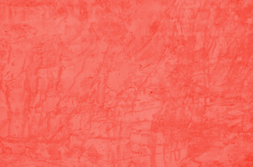 embossed cement shabby coral color wall. grunge background