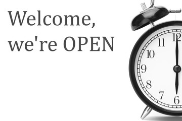 Welcome we're OPEN sign in gray and white, on shop door