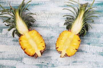 Two half of the fresh pineapple, located on a blue background, Top view, Horizontal format