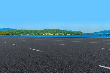 Empty asphalt road and natural landscape under the blue sky