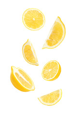 Cut fresh lemons falling against white background