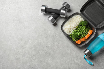 Flat lay composition with container of natural protein food on gray background