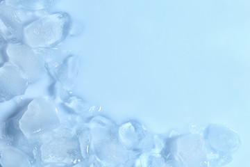 Melting ice cubes on color background, top view. Space for text
