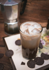 Iced coffee tray with milk and chocolate on wood background