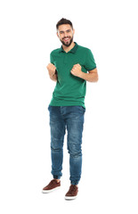 Happy young man celebrating victory on white background