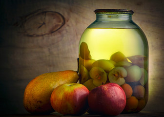 Home-made canned compote and fresh fruit on the basement shelf still life