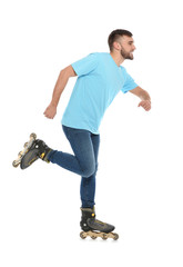Young man with inline roller skates on white background