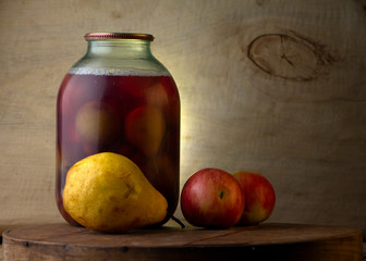 Obraz na płótnie Canvas Home-made canned compote and fresh fruit on the basement shelf still life