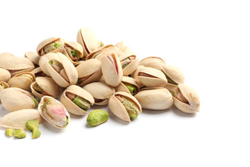 Heap of organic pistachio nuts isolated on white