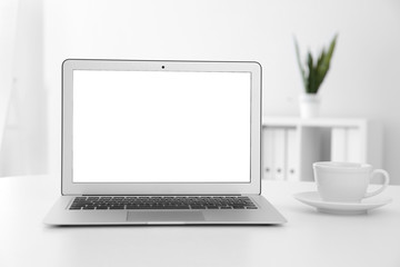 Fototapeta premium Comfortable workplace with modern laptop on table in office. Mockup for design