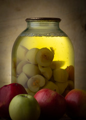 Home-made canned compote and fresh fruit on the basement shelf still life