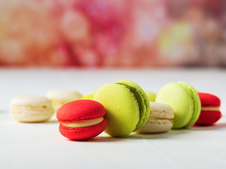 Sweet and colourful french macaroons on colorful spring background with copy space.