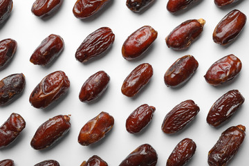 Sweet dried date fruits on white background, top view