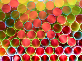 Drinking straw bundle from behind with colored illuminated, red