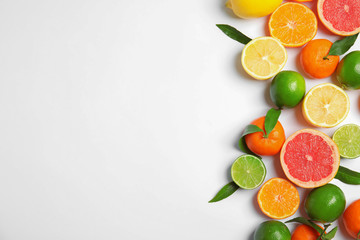Different citrus fruits on white background, top view. Space for text