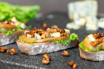 Snack bruschetta with pear, honey, walnut, cheese, green salad and olive oil 
