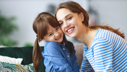 happy loving family mother and child daughter hugging at home.