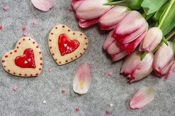 Valentines day frosted heart cookies with pink tulips background