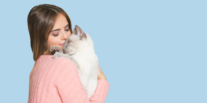 Young brunette with her cat.