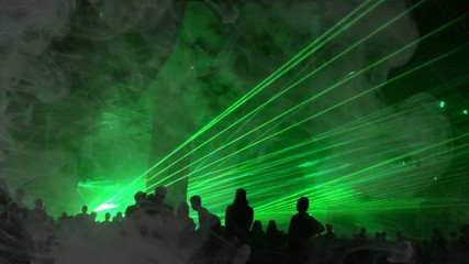 Cinemagraph - green laser rays and fog at a party. Psychedelic effect