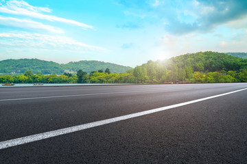 Naklejka premium Empty asphalt road square and natural landscape under the blue sky