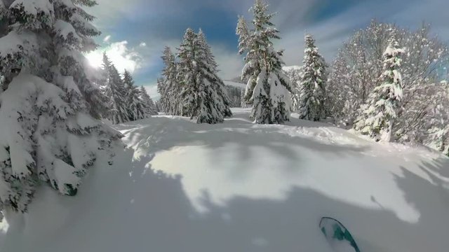 POV VR360: Snowboarding off piste down the untouched powder snow high in beautiful sunny mountains. Spectacular first person view of speeding downhill on a snowboard in the picturesque Slovenian Alps.