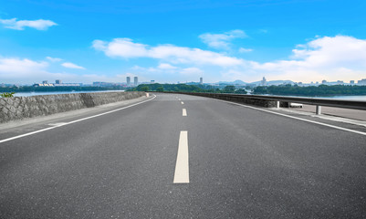 Fototapeta premium Empty asphalt road square and natural landscape under the blue sky