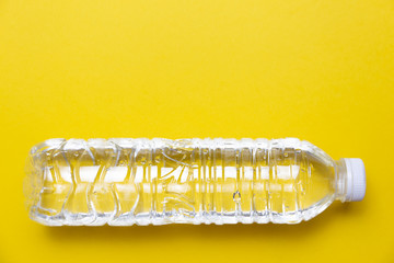 plastic bottle with water on yellow background