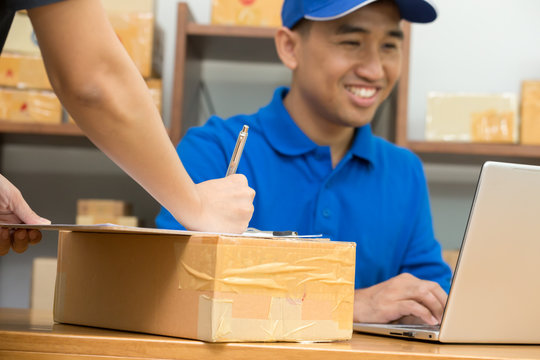 Employees receive parcels from customers and writing addresses for shipping products, Express counter of parcel delivery services to international and domestic, Ship a package concept