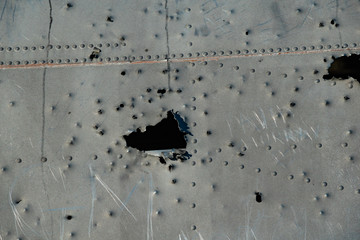Close up photo of bullet marks on the Abandoned DC Plane's fuselage on Solheimasandur, Iceland