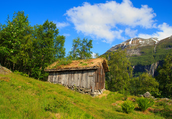 Old wooden house with grass roof in Norway