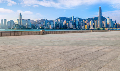Fototapeta premium Empty marble floors and city views under the blue sky