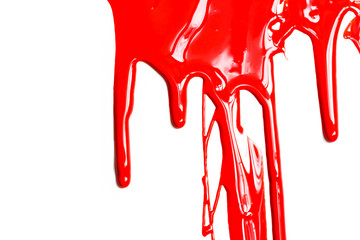 Flows of red glossy paint close-up on white background
