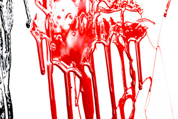 Red paint drips on a white background. Paint flows