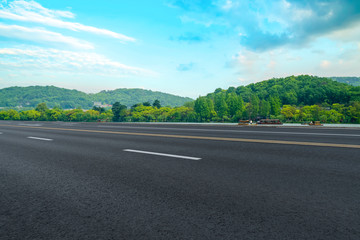 Empty asphalt road and natural landscape under the blue sky
