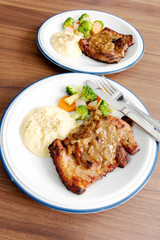 Pork steak with vegetables On the wood background