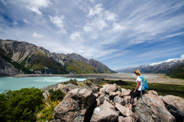 Woman tourist watching Tasman lake, New Zealand