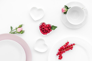 Empty white and pink colorful plate and wineberry for table setting on white table backgroung top view