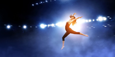 Obraz na płótnie Canvas Gymnast girl in jump Mixed media