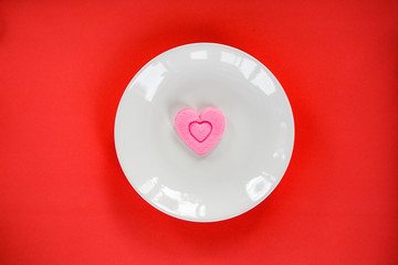Valentines dinner romantic love food and love cooking concept - Pink heart on white plate romantic table setting decorated with heart