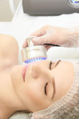 Obraz na płótnie Canvas Microcurrent facial dermatology procedure. Model. Aesthetic radiofrequency treatment. Micro current cosmetology massage