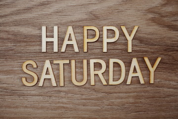 Fototapeta premium Happy Saturday text message on wooden background