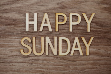 Fototapeta premium Happy Sunday text message on wooden background