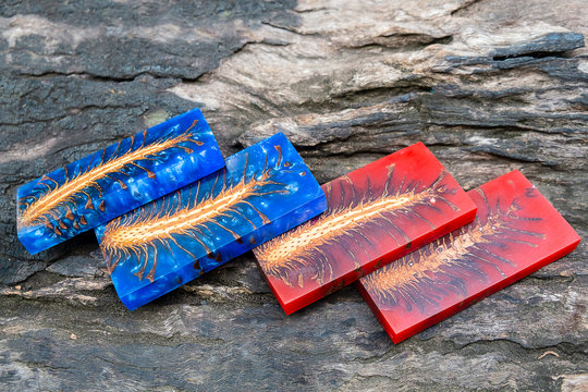 casting epoxy resin Stabilizing Pinecone red blue abstract art background, Texture of a wooden resin