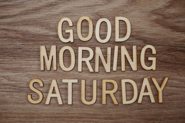 Good Morning Saturday text message on wooden background