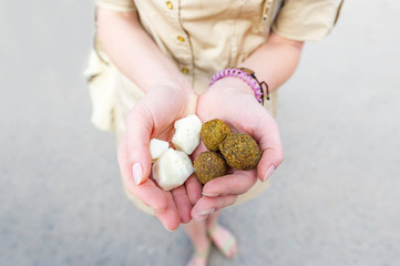 Holding sweet and tasty balls in hands.